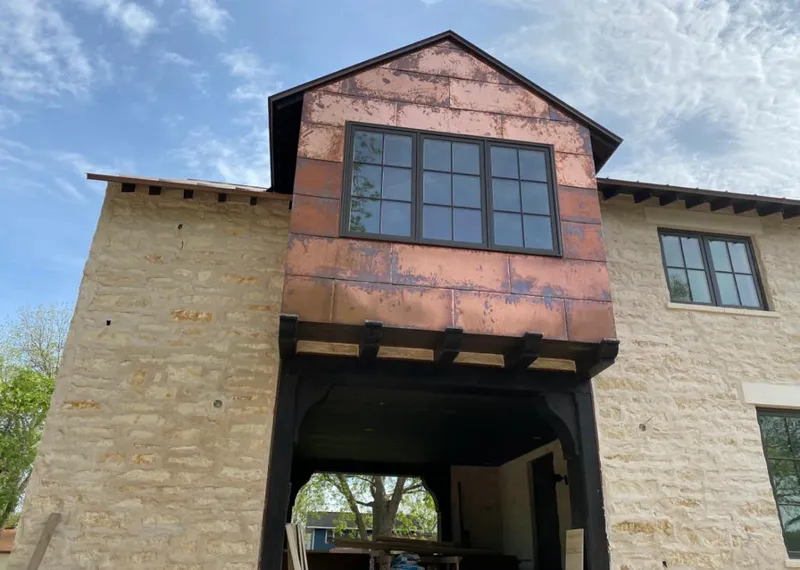 Copper metal panel facade on a stone building for Skylight Installation in Mount Juliet